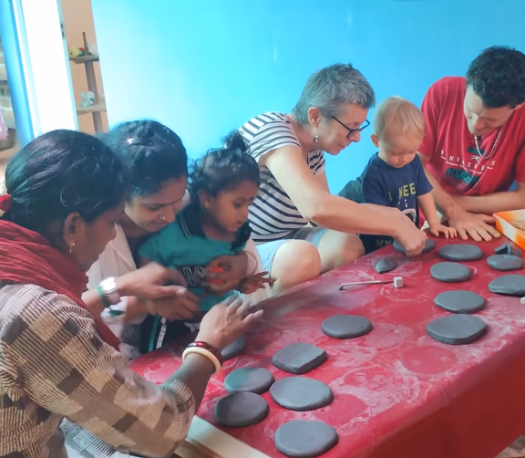 Juliette shows the children how to imprint clay tablets
