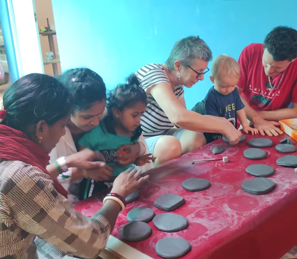 Juliette shows the children how to imprint clay tablets