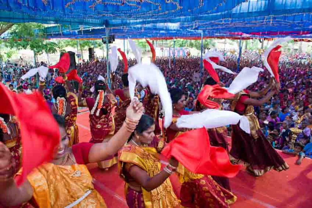 Women from AVAG's Women's Self-Help Groups perform in front of an audience of 5000 women