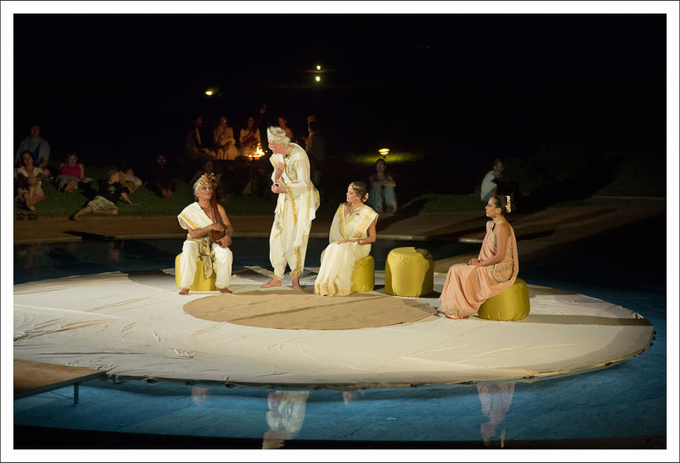 King Aswapati (standing) discusses the fate of Savitri with Narad, the heavenly messenger, while the Queen and Savitri look on