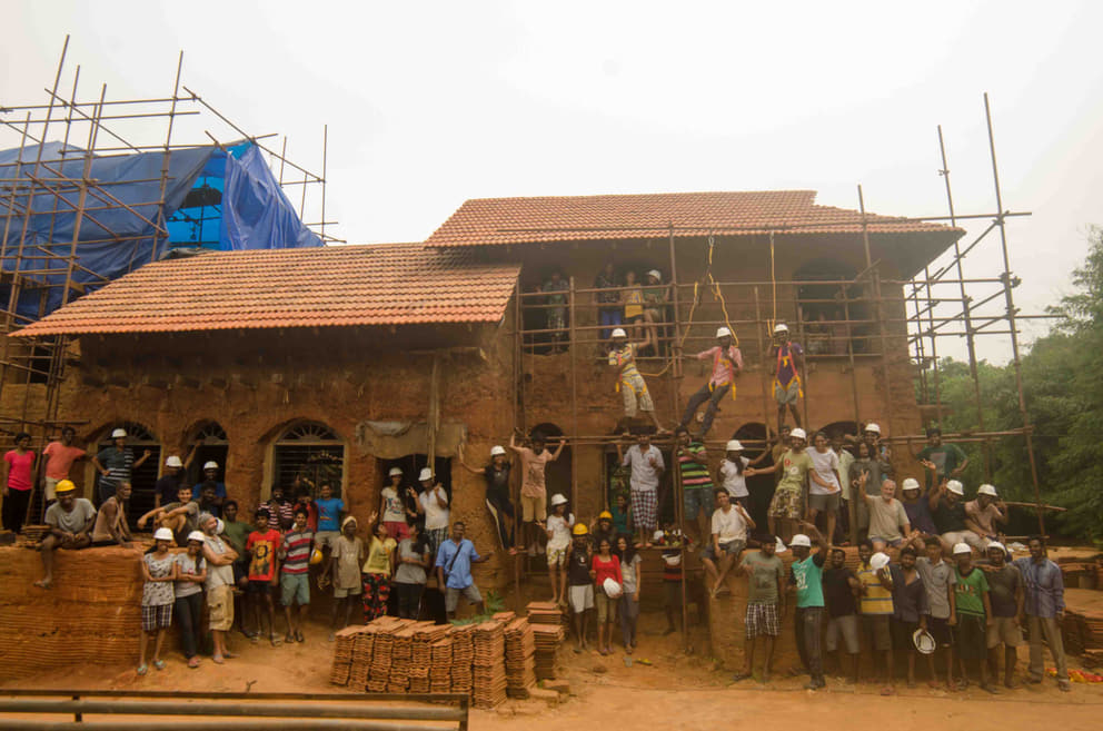 The three prototype buildings of Sacred Croves, with the Sacred Groves' team