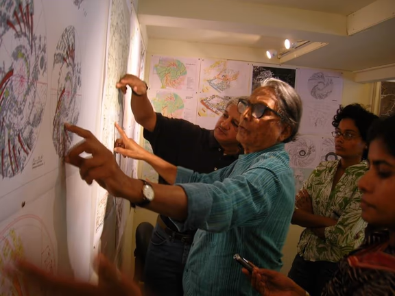 Former Governing Board member Dr B.V. Doshi discusses the Auroville Master Plan with Prashant in 2010, while Tejaswini and Meera look on