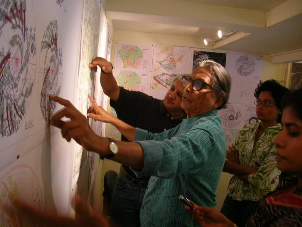 Former Governing Board member Dr B.V. Doshi discusses the Auroville Master Plan with Prashant in 2010, while Tejaswini and Meera look on