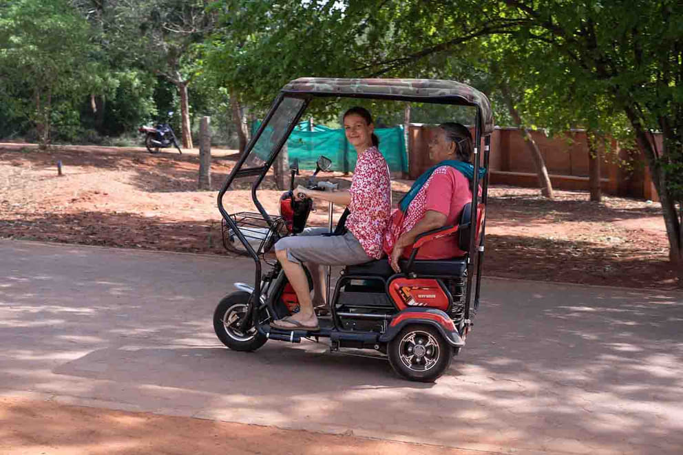 Paula with Prathiba, a resident of Mahalakshmi Home, in the electric three wheeler
