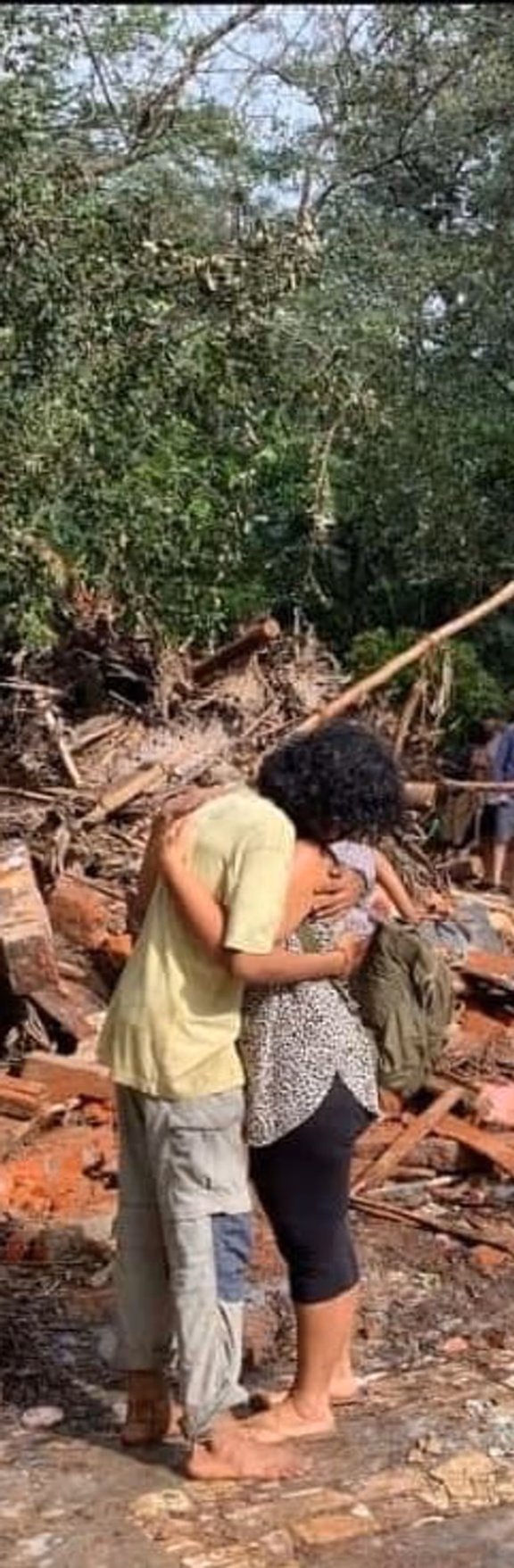Sharing a hug in the debris of the former Youth Centre