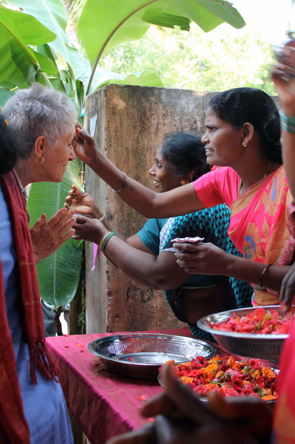 Welcoming a guest by applying gulaal