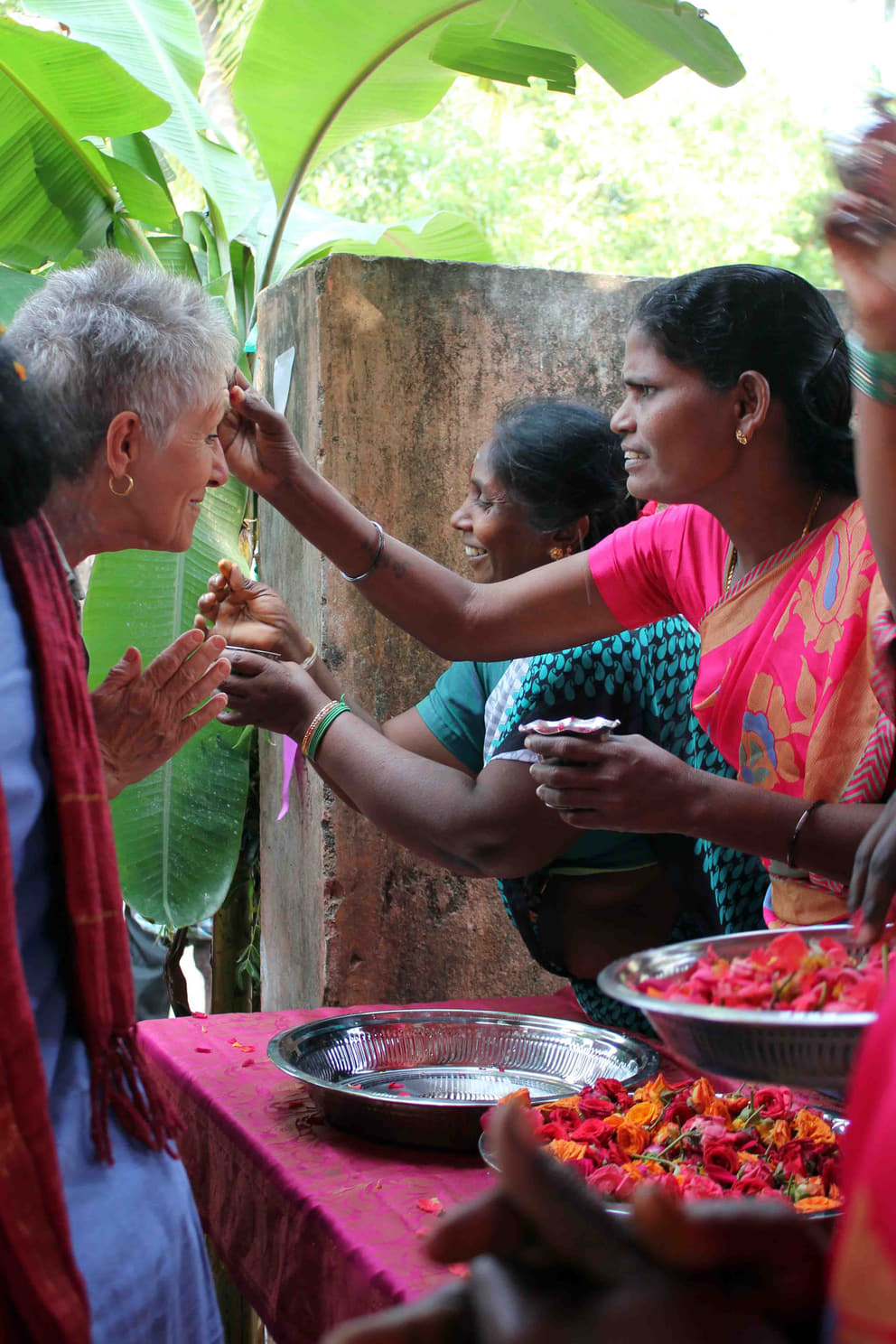 Welcoming a guest by applying gulaal