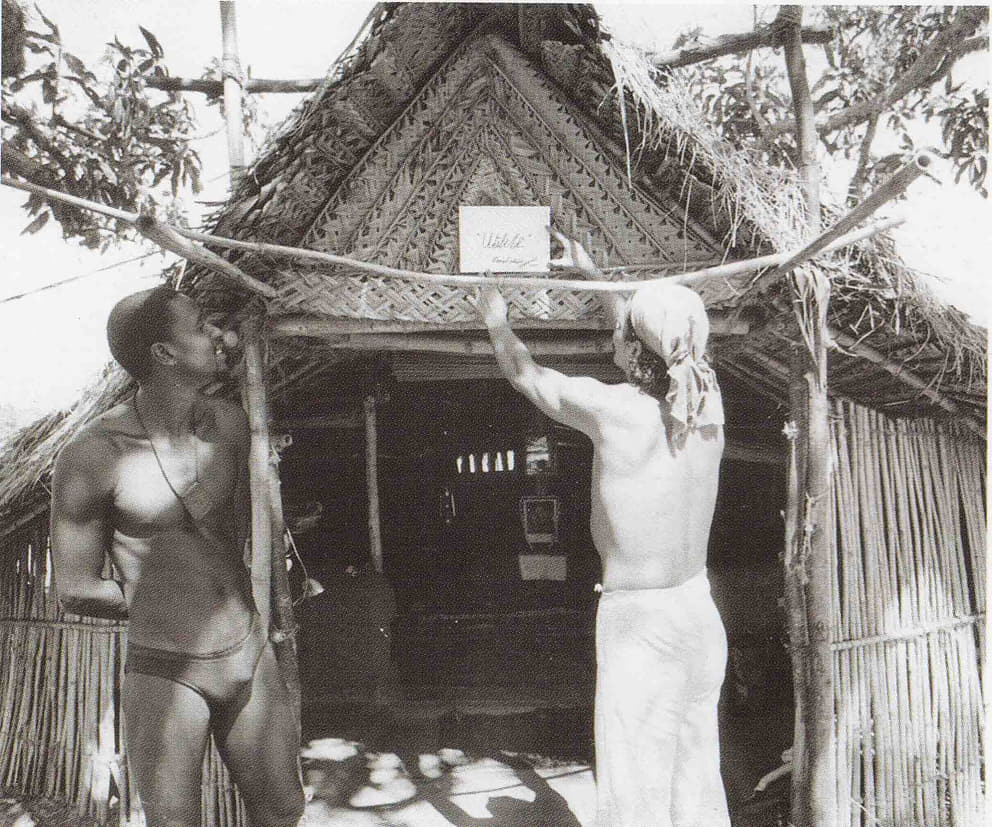 1 Krishna (left) and Mail fixing the name board of Utilité signed by The Mother with her blessing on their keet hut (1971)